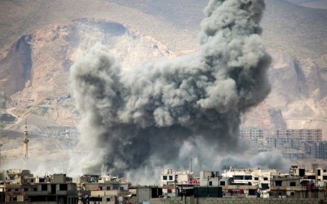 Illustrative: smoke billows following a reported air strike in the rebel-held parts of the Jobar district, on the eastern outskirts of the Syrian capital Damascus, on March 20, 2017. (AFP PHOTO / AMER ALMOHIBANY)