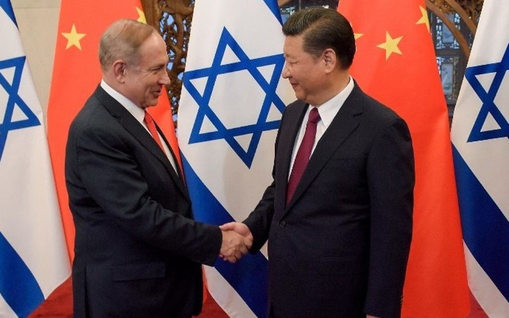 Prime Minister Benjamin Netanyahu and China's President Xi Jinping (R) shake hands ahead of their talks at Diaoyutai State Guesthouse in Beijing, on March 21, 2017. (AFP Photo/Pool/Etienne Oliveau)