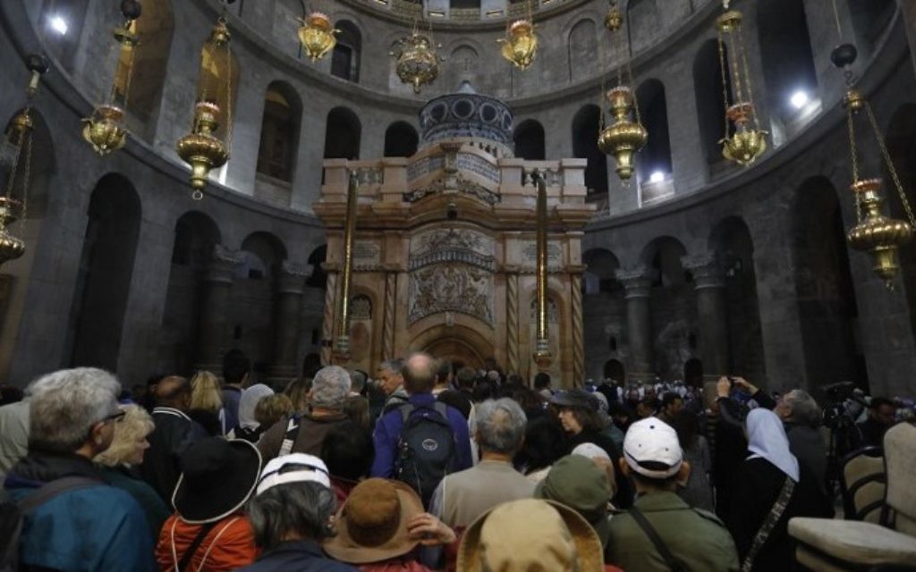 Tourists and worshippers wait to access the newly restored shrine surrounding what is believed to be Jesus's tomb which was unveiled at a ceremony in Jerusalem on March 22, 2017 following months of delicate work. (Menahem Kahana/AFP) Tourists and worshippers wait to access the newly restored shrine surrounding what is believed to be Jesus's tomb which was unveiled at a ceremony in Jerusalem on March 22, 2017 following months of delicate work. (Menahem Kahana/AFP)