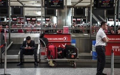 Officials wait for US passengers at a check-in area on March 22, 2017 at the Ataturk International Airport in Istanbul. (Ozan Kose/AFP) 
