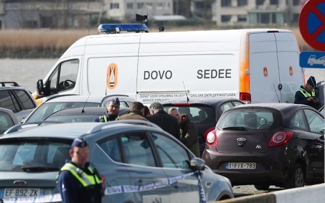 Police officers and and Sedee-Dovo, the mine clearance service of Belgian defense, patrol in Antwerp where Belgian police arrested a man on March 23, 2017 after he tried to drive into a crowd at high-speed in a shopping area in the port city of Antwerp, a police chief said. (AFP/Belga/VIRGINIE LEFOUR)