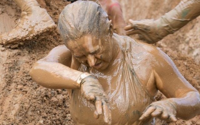 Participants take part in the Mud Day race, a 13km obstacle course, on March 24, 2017 in the Israeli Mediterranean coastal city of Tel Aviv. (Jack Guez/AFP)