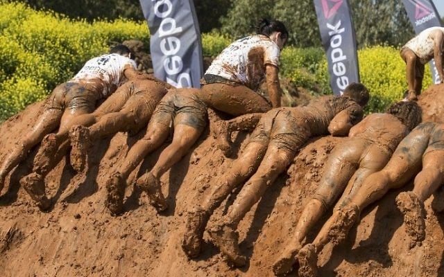 Participants take part in the Mud Day race, a 13km obstacle course, on March 24, 2017 in the Israeli Mediterranean coastal city of Tel Aviv. (Jack Guez/AFP)