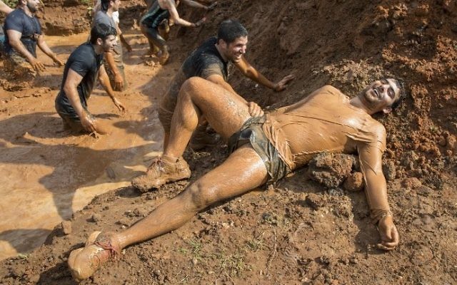 Participants take part in the Mud Day race, a 13km obstacle course, on March 24, 2017 in the Israeli Mediterranean coastal city of Tel Aviv. (Jack Guez/AFP)