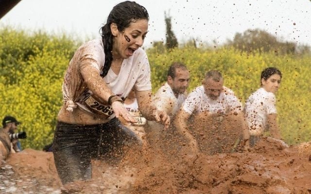 Participants take part in the Mud Day race, a 13km obstacle course, on March 24, 2017 in the Israeli Mediterranean coastal city of Tel Aviv. (Jack Guez/AFP)