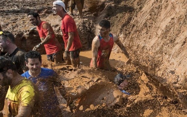 Participants take part in the Mud Day race, a 13km obstacle course, on March 24, 2017 in the Israeli Mediterranean coastal city of Tel Aviv. (Jack Guez/AFP)