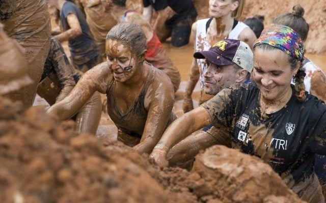 Participants take part in the Mud Day race, a 13km obstacle course, on March 24, 2017 in the Israeli Mediterranean coastal city of Tel Aviv. (Jack Guez/AFP)