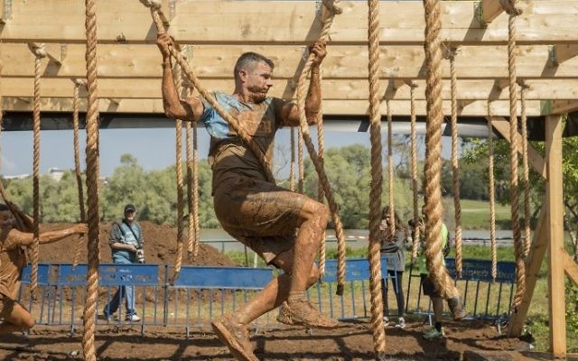 Participants take part in the Mud Day race, a 13km obstacle course, on March 24, 2017 in the Israeli Mediterranean coastal city of Tel Aviv. (Jack Guez/AFP)