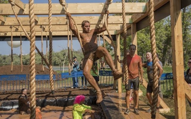 Participants take part in the Mud Day race, a 13km obstacle course, on March 24, 2017 in the Israeli Mediterranean coastal city of Tel Aviv. (Jack Guez/AFP)
