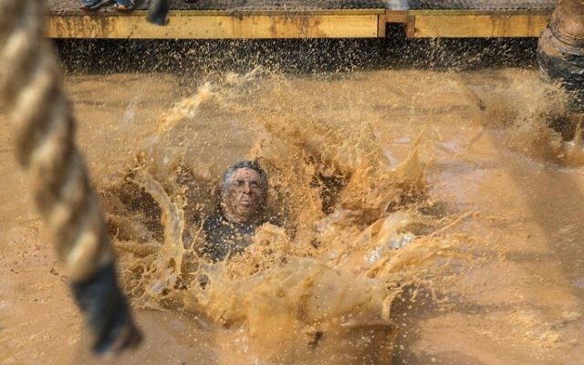 Participants take part in the Mud Day race, a 13km obstacle course, on March 24, 2017 in the Israeli Mediterranean coastal city of Tel Aviv. (Jack Guez/AFP)