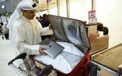 Kuwaiti social media activist Thamer al-Dakheel Bourashed puts his laptop inside his suitcase at Kuwait International Airport in Kuwait City, before boarding a flight to the United States on March 23, 2017. (AFP/Yasser Al-Zayyat)