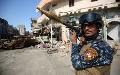 A member of the Iraqi forces stands guard at the frontline of the Old City of Mosul on March 25, 2017, during the government forces' ongoing offensive to retake the city from Islamic State (IS) group fighters. (AFP/Ahmad Al-Rubaye)
