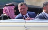 Saudi Arabia's King Salman bin Abdulaziz al-Saud and Jordanian King Abdullah II sit in a vintage car during a welcome ceremony  at the airport in the Jordanian capital Amman on March 27, 2017 ahead of the 28th Summit of the Arab League.   / AFP PHOTO / Khalil MAZRAAWI