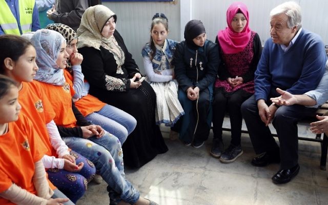 United Nations Secretary General Antonio Guterres (R) talks to Syrian women and girls during a visit to the Zaatari refugee camp which shelters some 80,000 Syrian refugees on the Jordanian border with war-ravaged Syria on March 28, 2017. (AFP Photo/Thomas Coex)