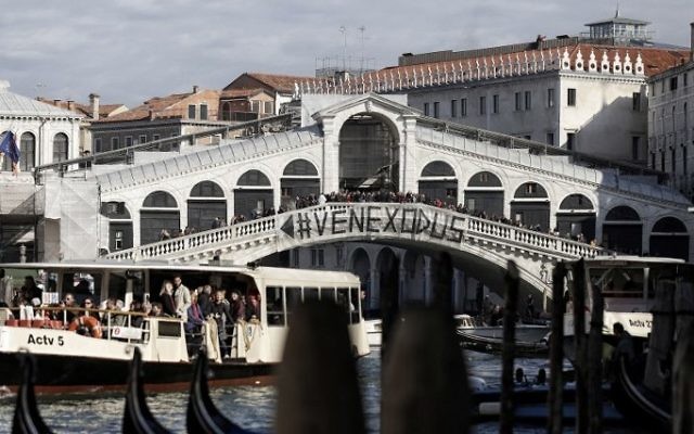 This file photo taken on November 12, 2016 shows people gathering on the Rialto Bridge during a demonstration against the increasing number of tourists in Venice. (AFP /Marco Bertorello) This file photo taken on November 12, 2016 shows people gathering on the Rialto Bridge during a demonstration against the increasing number of tourists in Venice. (AFP /Marco Bertorello)