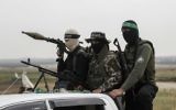 Members of the Izz ad-Din al-Qassam Brigades, the military wing of the Palestinian terror group Hamas, at a rally to mark Land Day near the Israeli border with east Rafah in the southern Gaza Strip, March 30, 2017. (AFP/Said Khatib)