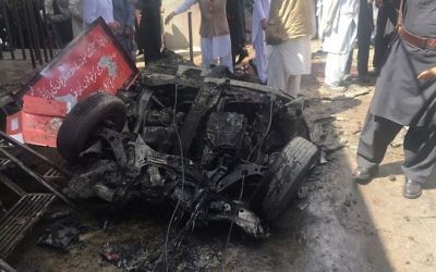 Pakistani security officials and residents gather at the site of a powerful explosion at a market in Parachinar, capital of the Kurram tribal district, on March 31, 2017. (AFP)