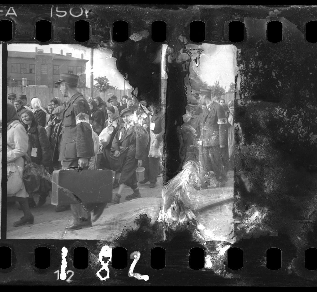 A damaged negative of ghetto police escorting residents for deportation. (Henryk Ross/Art Gallery of Ontario, gift from the Archive of Modern Conflict/Courtesy Museum of Fine Arts) A damaged negative of ghetto police escorting residents for deportation. (Henryk Ross/Art Gallery of Ontario, gift from the Archive of Modern Conflict/Courtesy Museum of Fine Arts)