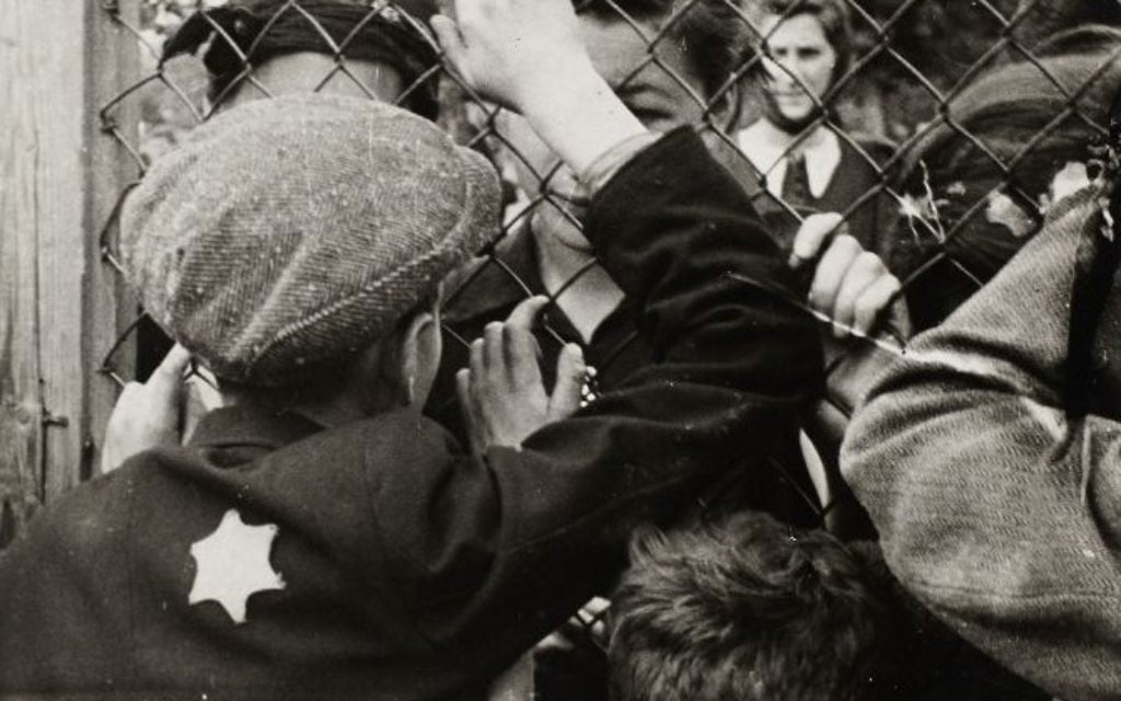 Children talking through the fence of the central prison on Czarneck Street prior to deportation. (Henryk Ross/Art Gallery of Ontario, gift from the Archive of Modern Conflict/Courtesy Museum of Fine Arts)