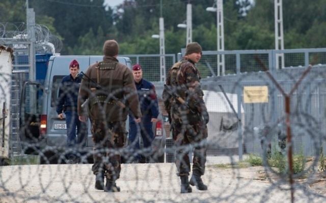 In this Sept. 21, 2016 file photo Hungarian soldiers, front, and police officers patrol at the transit zone at Hungary's southern border with Serbia near Tompa, 169 km southeast of Budapest, Hungary. (Sandor Ujvari/MTI via AP, file) In this Sept. 21, 2016 file photo Hungarian soldiers, front, and police officers patrol at the transit zone at Hungary's southern border with Serbia near Tompa, 169 km southeast of Budapest, Hungary. (Sandor Ujvari/MTI via AP, file)