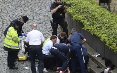 Emergency services at the scene outside the Palace of Westminster, London, Wednesday, March 22, 2017, following a terrorist attack. (Stefan Rousseau/PA via AP).
