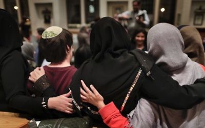 In this Thursday, February 16, 2017 photo, members of the Sisterhood Salaam Shalom, gather for a group photo after a unity vigil held at the Jewish Theological Seminary in New York. (AP/Julie Jacobson)