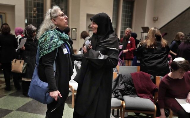 In this Thursday, Feb. 16, 2017 photo, members of the Sisterhood Salaam Shalom talk after a unity vigil held at the Jewish Theological Seminary in New York. (AP/Julie Jacobson)