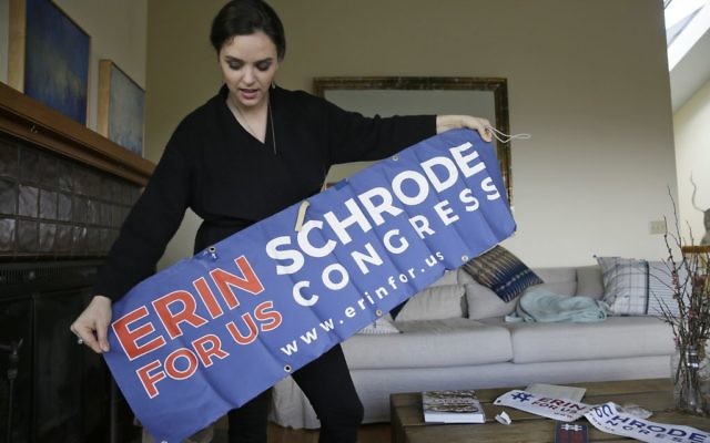 Erin Schrode unfurls a campaign banner for her long-shot congressional campaign, February 21, 2017. (AP Photo/Eric Risberg)
