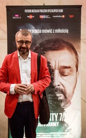 Bogdan Bialek in front of a movie poster for the documentary 'Bogdan's Journey.' (Courtesy)