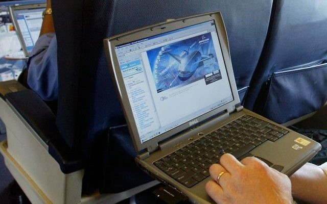 Illustrative photo of a laptop being used on a plane. (Chris Ison/PA, File via AP)