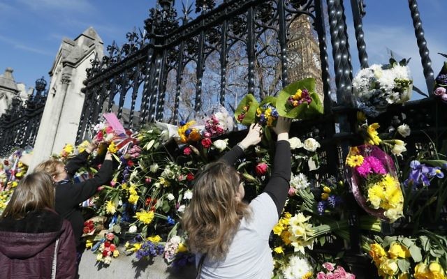 People place flowers outside Britain's parliament in London, Saturday March 25, 2017, for the victims of the Westminster terror attack. (AP Photo/Kirsty Wigglesworth) People place flowers outside Britain's parliament in London, Saturday March 25, 2017, for the victims of the Westminster terror attack. (AP Photo/Kirsty Wigglesworth)