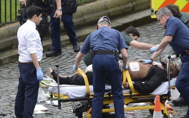 In this March 22, 2017 photo, Khalid Masood is treated by emergency services after a fatal attack outside the Houses of Parliament, London. British Police named Masood on March 23, 2017, as the terrorist who carried out the attack. (Stefan Rousseau/PA via AP). In this March 22, 2017 photo, Khalid Masood is treated by emergency services after a fatal attack outside the Houses of Parliament, London. British Police named Masood on March 23, 2017, as the terrorist who carried out the attack. (Stefan Rousseau/PA via AP).