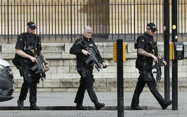 Armed police officers enter the Houses of Parliament in London, Wednesday, March 23, 2017 after the House of Commons sitting was suspended as witnesses reported sounds like gunfire outside. (AP Photo/Kirsty Wigglesworth)