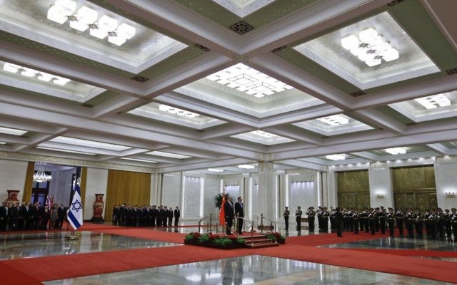 Prime Minister Benjamin Netanyahu, center left, and Chinese Premier Li Keqiang stand on the podium as they listen to the national anthems during a welcome ceremony at the Great Hall of the People in Beijing, Monday, March 20, 2017. (AP Photo/Andy Wong) Prime Minister Benjamin Netanyahu, center left, and Chinese Premier Li Keqiang stand on the podium as they listen to the national anthems during a welcome ceremony at the Great Hall of the People in Beijing, Monday, March 20, 2017. (AP Photo/Andy Wong)
