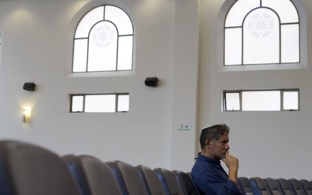 In this March 19, 2017 photo, Franklin Perez, listens to a rabbi at a synagogue in Bogota, Colombia. (AP Photo/Christine Armario)