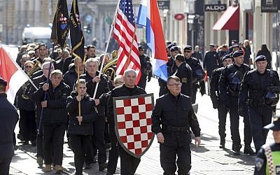 In this photo taken Sunday, Feb. 26, 2017, a group of right-wing radicals wave Croatian and US flags as they march through downtown Zagreb. (AP Photo)