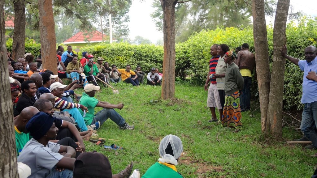 After three hours of weeding and pruning a dirt path, the residents of Kimana Village in Kigali, Rwanda gathered for an hour-long community meeting on February 25, 2017. (Melanie Lidman/Times of Israel) 