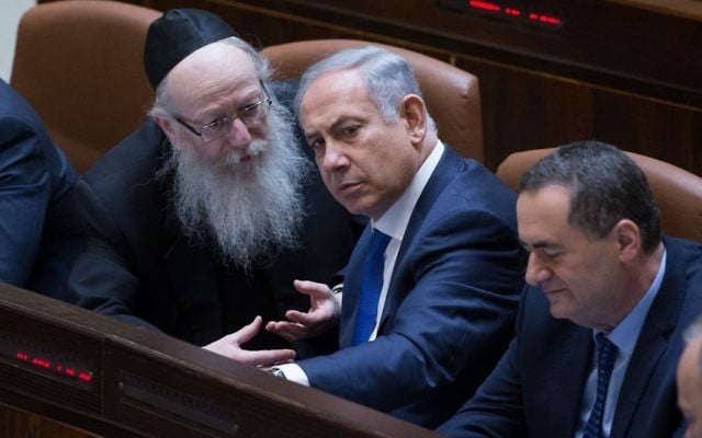 Prime Minister Benjamin Netanyahu (c) speaks with then-health minister Yaakov Litzman (l) at the Knesset on March 28, 2016. (Yonatan Sindel/Flash90) Prime Minister Benjamin Netanyahu (c) speaks with then-health minister Yaakov Litzman (l) at the Knesset on March 28, 2016. (Yonatan Sindel/Flash90)