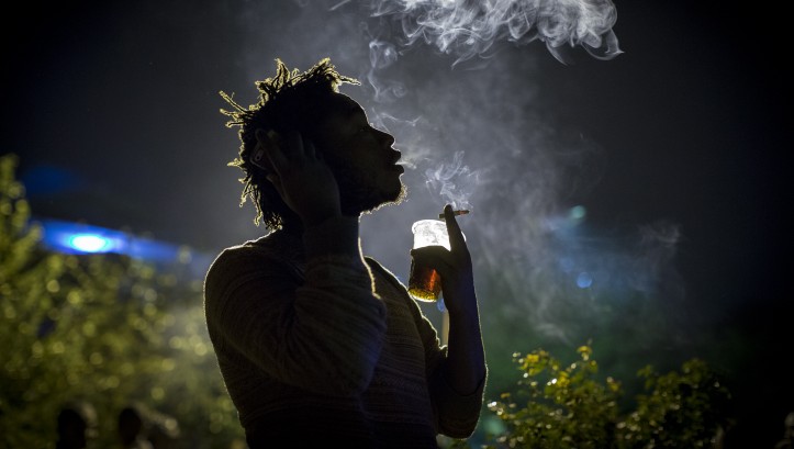 An artist takes a cigarette break during the weekly Thursday Happy Hour concert at the Inema Arts Center in Kigali, Rwanda on February 17, 2017. (Miriam Alster/Flash90) 