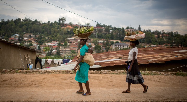 Women walk with fruit on their head in the Rwandan capital of Kigali on February 18, 2017. (Miriam Alster/Flash90)