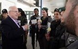 President Reuven Rivlin gives Purim packages (Mishloach Manot) to members of the Israeli security forces guarding at the Ofer checkpoint on March 12, 2017. (Mark Neyman/GPO)