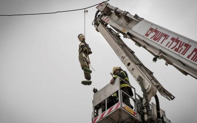 A firefighter takes down a large doll dressed as an ultra-Orthodox Jewish soldier hung in the ultra-Orthodox Jerusalem neighborhood of Mea Shearim, on March 13, 2017. (Nati Shohat/Flash90) A firefighter takes down a large doll dressed as an ultra-Orthodox Jewish soldier hung in the ultra-Orthodox Jerusalem neighborhood of Mea Shearim, on March 13, 2017. (Nati Shohat/Flash90)