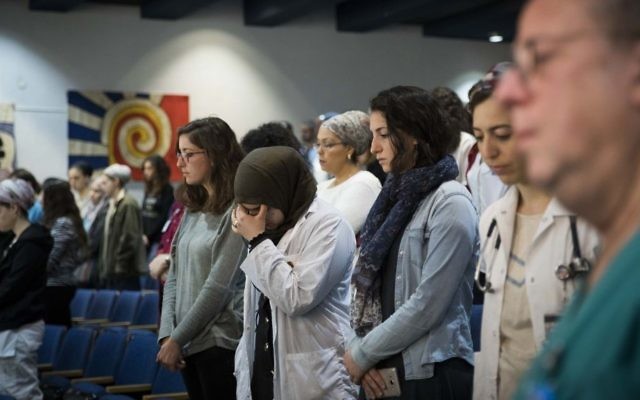 Staff at Hadassah Hospital on Mt. Scopus on March 15, 2017 observe a minute of silence in memory of Tova Kararo, a Holon nurse killed by a disgruntled and mentally ill patient a day earlier. (Yonatan Sindel/Flash90) 
