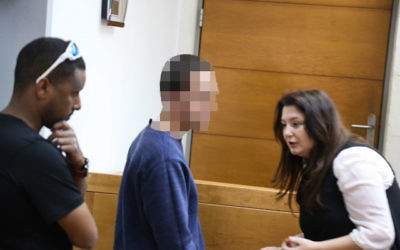 A Jewish Israeli teen is brought for a court hearing at the Rishon Lezion Magistrate's Court, on suspicion of issuing fake bomb threats against Jewish institutions in the US and around the world, on March 23, 2017. At right is his lawyer, Galit Besh (Flash90) A Jewish Israeli teen is brought for a court hearing at the Rishon Lezion Magistrate's Court, on suspicion of issuing fake bomb threats against Jewish institutions in the US and around the world, on March 23, 2017. At right is his lawyer, Galit Besh (Flash90)