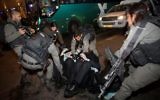 Israeli police officers clash with ultra-Orthodox Jewish men during an anti-draft protest in Jerusalem on March 23, 2017. (Yonatan Sindel/Flash90)