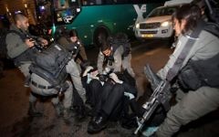Israeli police officers clash with ultra-Orthodox Jewish men during an anti-draft protest in Jerusalem on March 23, 2017. (Yonatan Sindel/Flash90)