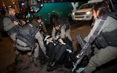 Israeli police officers clash with ultra-Orthodox Jewish men during an anti-draft protest in Jerusalem on March 23, 2017. (Yonatan Sindel/Flash90)