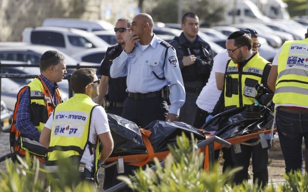 Israeli paramedics and security forces near the body of an alleged Palestinian attacker who attempted to stab police officers guarding Damascus Gate in Jerusalem's Old City on March 29, 2017. (Hadas Parush/Flash90)