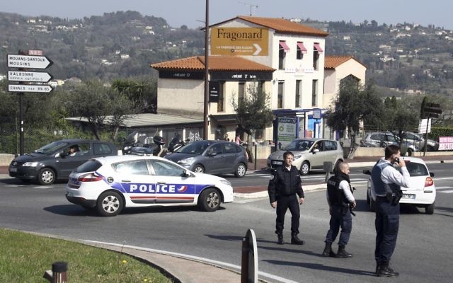 Police officers take position after an attack in a high school student in Grasse, southern France, March 16, 2017. (AP Photo/Philippe Farjon)