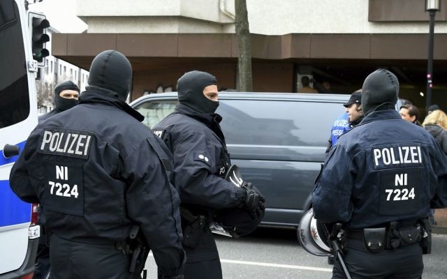 Police guard outside the Islamic Society of Hildesheim (DIK) mosque after a raid in Hildesheim, Germany, Tuesday, March 14, 2017. (Holger Hollemann/dpa via AP)